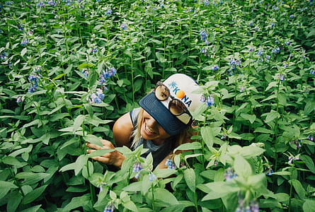 woman surrounded by purple petaled flowers thumbnail