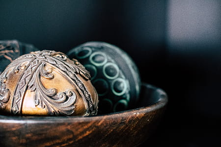 Brown and Two Black Ball in Bowl Photography thumbnail