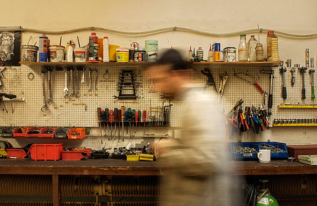 person wearing gray long-sleeved top beside workbench thumbnail