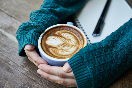 person holding blue and white ceramic mug thumbnail