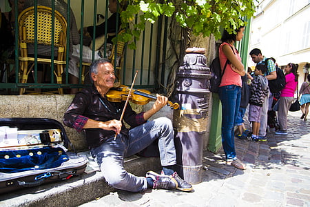 man playing violin near fence thumbnail