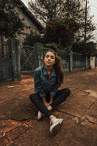 woman sitting on ground near gate thumbnail