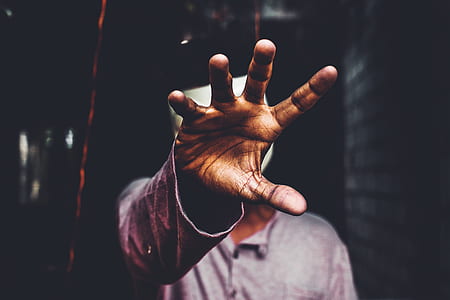man wearing gray top raising right arm thumbnail