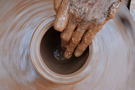 person making clay pot thumbnail