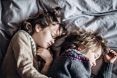 two girls sleeping on bed thumbnail