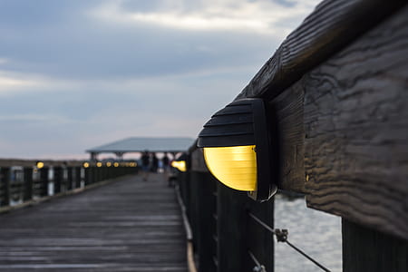 focus photography of dock sidewalk post lamp thumbnail