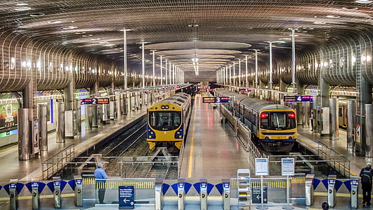 two yellow trains on train rails thumbnail