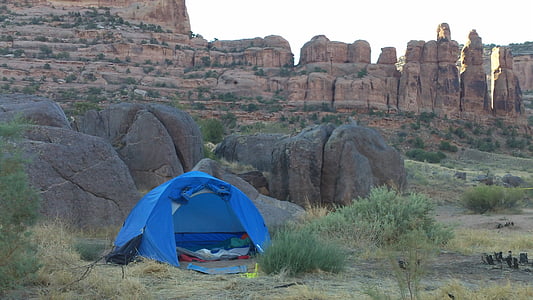 blue tent beside rocks thumbnail