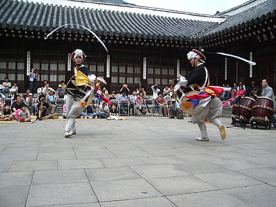 two person dancing traditional dance surrounded by people during daytime thumbnail