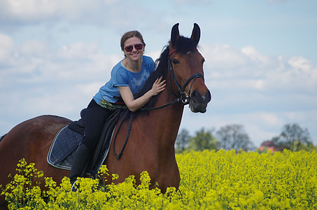 woman riding a horse on flower field thumbnail