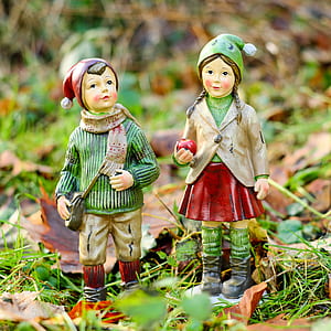 girl and a boy in green and red bobble hat figurines thumbnail