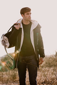 man holding duffel bag thumbnail