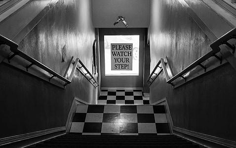 staircase with please watch your step signage on door thumbnail