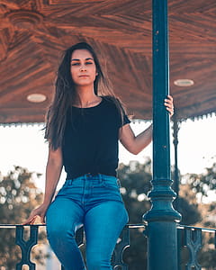 Woman Sitting Om Fence thumbnail