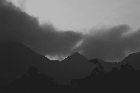silhouette of mountains under gray sky thumbnail