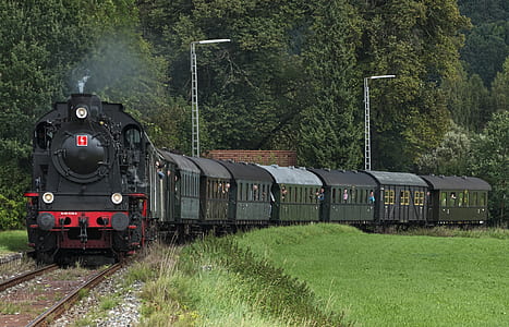 black train near trees thumbnail