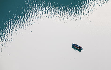 aerial photo of persons on rowboat during daytime thumbnail