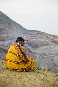 A cliff watcher wrapped in sheet on a cold day thumbnail