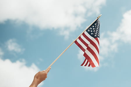 person holding U.S.A. flag thumbnail