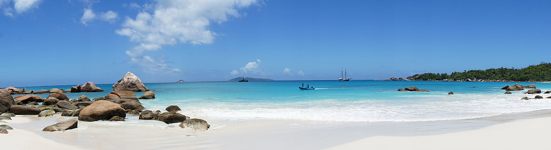 white sand and blue body of water photo taken during daytime thumbnail