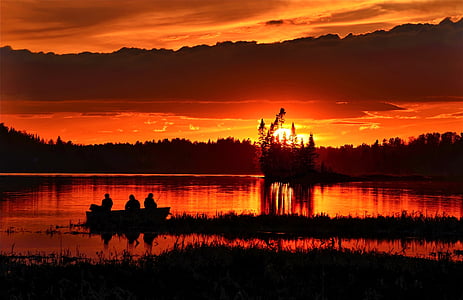 silhouette of three person on boat during sunset thumbnail