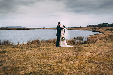 bride and groom standing near the pond thumbnail