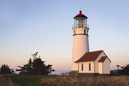 landscape photography of white and red lighthouse thumbnail