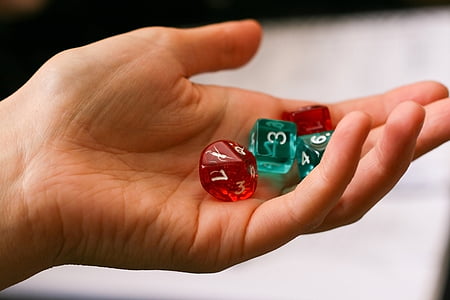 person holding red-and-teal dice thumbnail