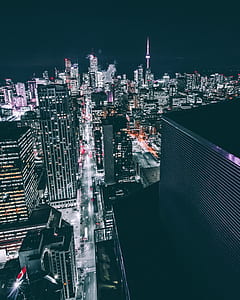 top view photo of asphalt road between city buildings during night time thumbnail