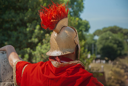 man wearing beige helmet and red cape during daytime thumbnail