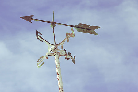 low angle photography of white wind vane under blue sky and white clouds thumbnail