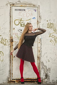 woman posing in front of a building door thumbnail