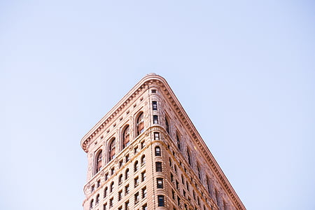 brown concrete building under clear blue sky thumbnail