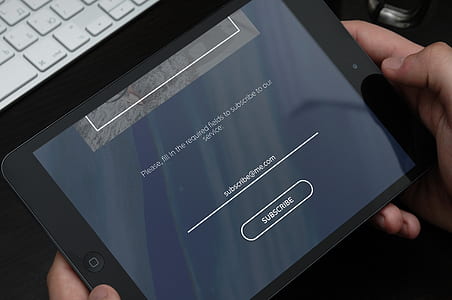 person holding black iPad thumbnail