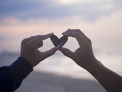 person holding black heart-form stone thumbnail