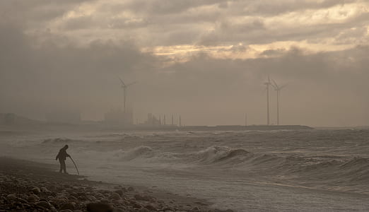 person standing on shore during daytime thumbnail