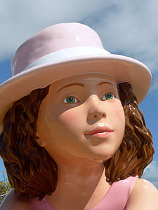 closeup photo of girl wearing sun hat figurine thumbnail