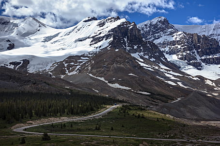 pathway heading toward white snow covered mountain thumbnail