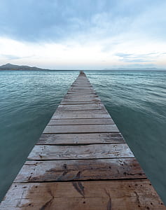 photography of dock bridge surrounded with body of water thumbnail