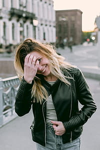 Photo of Woman Wearing Black Zip-up Leather Jacket and White and Black Striped Shirt thumbnail