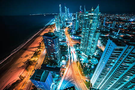aerial view of blue high rise building during nighttime thumbnail