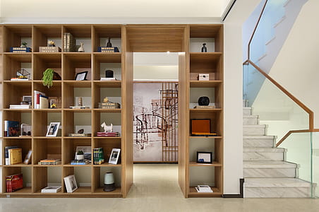 brown wooden cubby shelf with assorted-color decors thumbnail