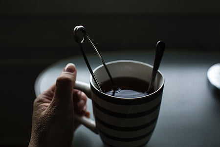 person holding mug with safety pin thumbnail