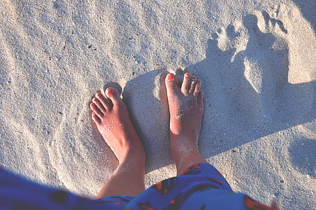 person in blue Superman towel standing on gray sand during daytime thumbnail