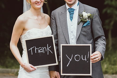 couple holding thank you boards thumbnail