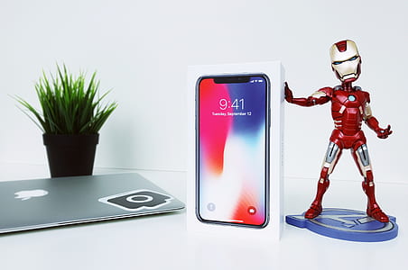 space gray iPhone X box beside Iron-Man bobblehead thumbnail