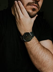 man wearing round black analog watch at 3:00:56 thumbnail