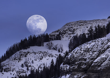 landscape photography of snow covered mountain with moon as background thumbnail