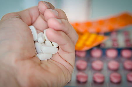White Oval Medication Tablets in Hand thumbnail