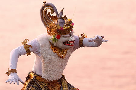 person wearing white and brown costume with headdress thumbnail